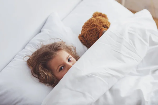 Sweet Little Girl Hiding Teddy Bear Her Blanket While Lying — Stock Photo, Image