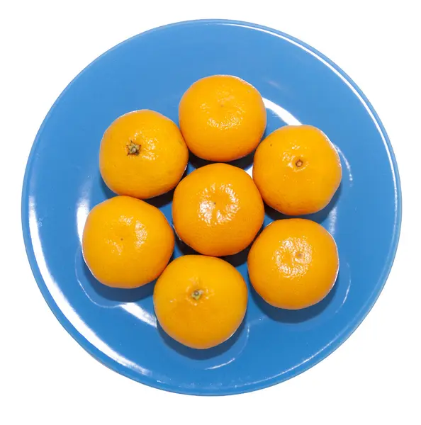 Mandarins em placa azul — Fotografia de Stock