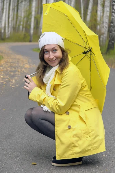 Girl in autumn forest with yellow umbrella — Stock Photo, Image