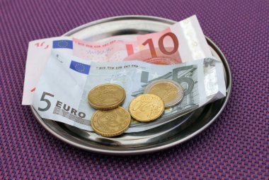 Euro tips on restaurant table clipart