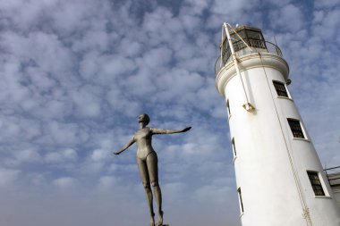Lighthouse and diving belle statue clipart