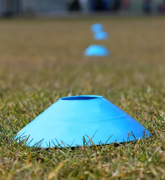 Sports training cones on soccer pitch — Stock Photo, Image