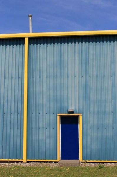 Blue and yellow warehouse building — Stock Photo, Image