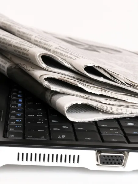 Newspapers on the notebook — Stock Photo, Image