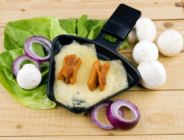 Raclette pan with cheese and bacon - party food — Stock Photo, Image