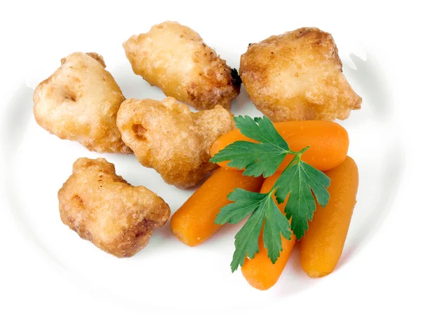 Stekt kyckling nuggets med minimorötter Stockbild