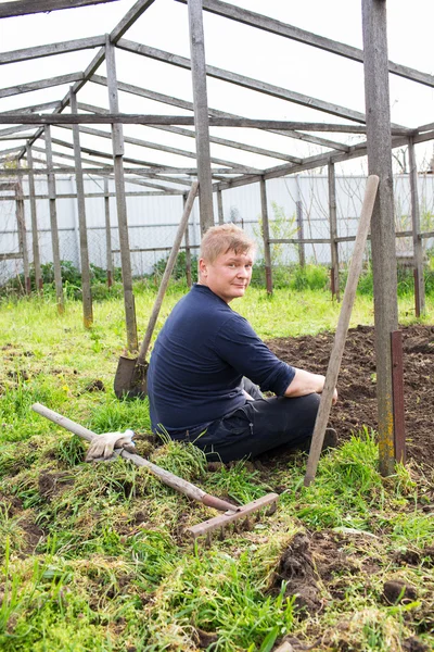 A man sits in the garden