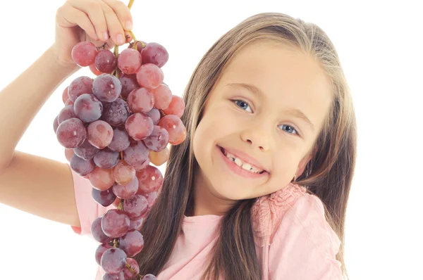 Weinig meisje eten druif — Stockfoto