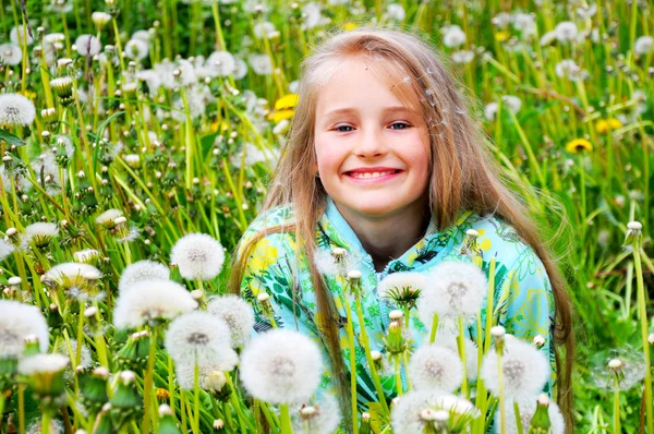 Little girl and yellow dandelion — Stock Photo, Image