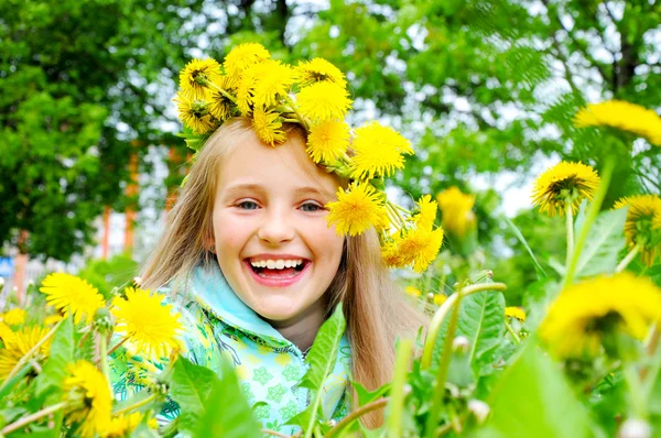 Little girl and yellow dandelion — Stock Photo, Image