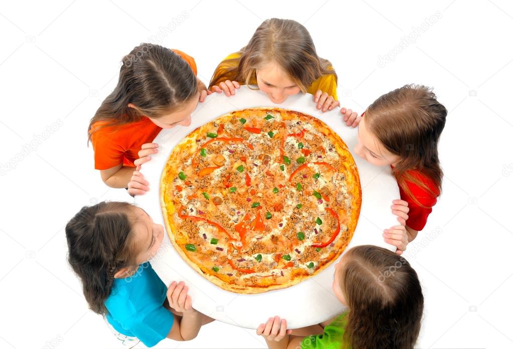 Children eating huge pizza