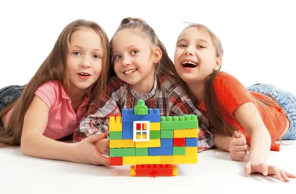 Children playing a toy house Royalty Free Stock Images