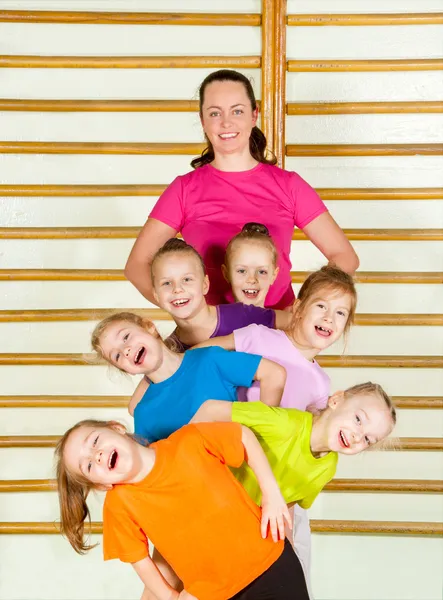 Happy sporty children with coach — Stock Photo, Image