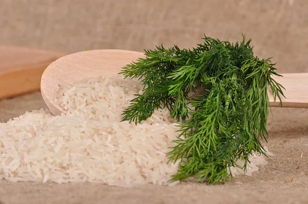 Rice with dill and spoon on the canvas — Stock Photo, Image