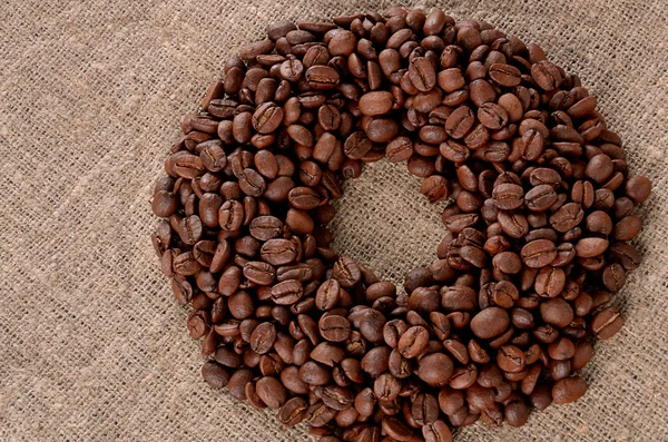Кофе зерно на фоне холста — стоковое фото