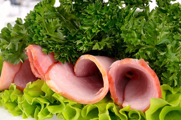 Slices of ham with parsley and salad leaf isolated on white back — Stock Photo, Image
