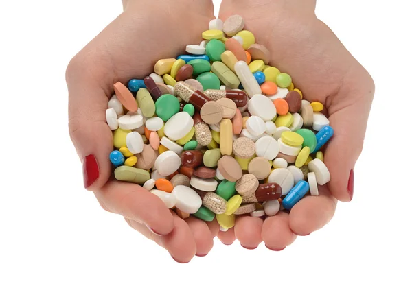 Stack of different pills in woman hands isolated on white backgr — Stock Photo, Image