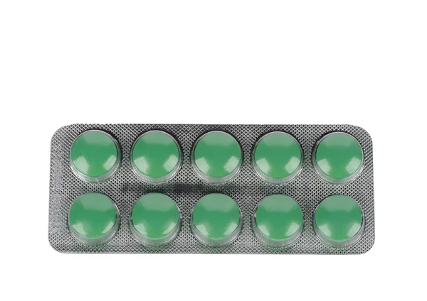 Pílulas verdes em bolhas no fundo branco — Fotografia de Stock
