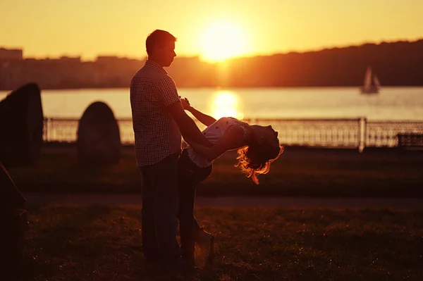 Couple in love back light silhouette at lake orange sunset — Stock Photo, Image