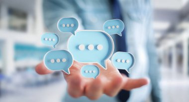 Dijital mavi konuşma baloncukları kullanan bir iş adamı ikonlar hakkında konuşur. Kullanıcı elinde asgari sohbet ya da sosyal medya mesajları yüzüyor. 3B görüntüleme