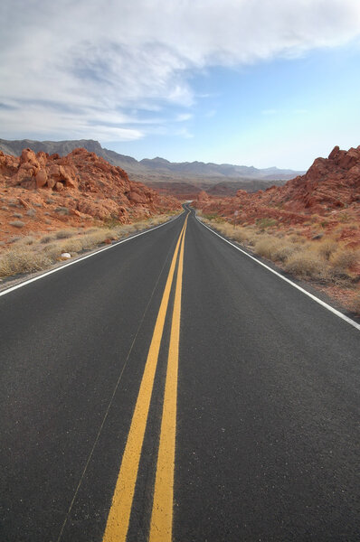 Deserted road stretching toward the horizon in the Valley of Fire State Park, Nevada