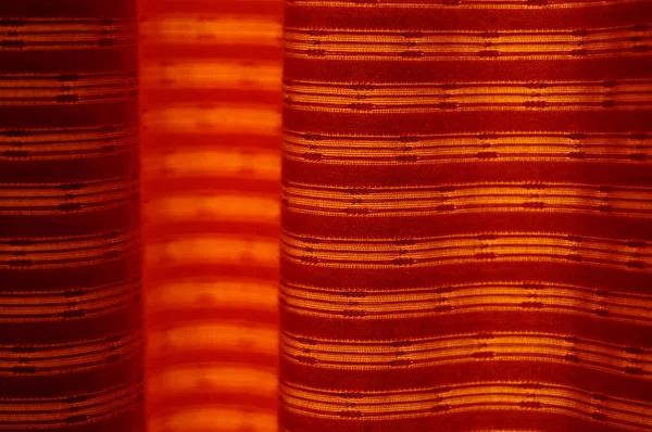 A vibrant orange curtain backlit by the sun. Photo texture — Stock Photo, Image