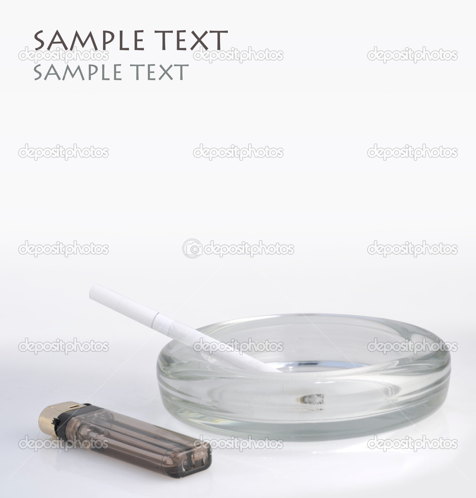 A smoking cigarette in a modern glass ashtray with a lighter, isolated on white - ideal for 