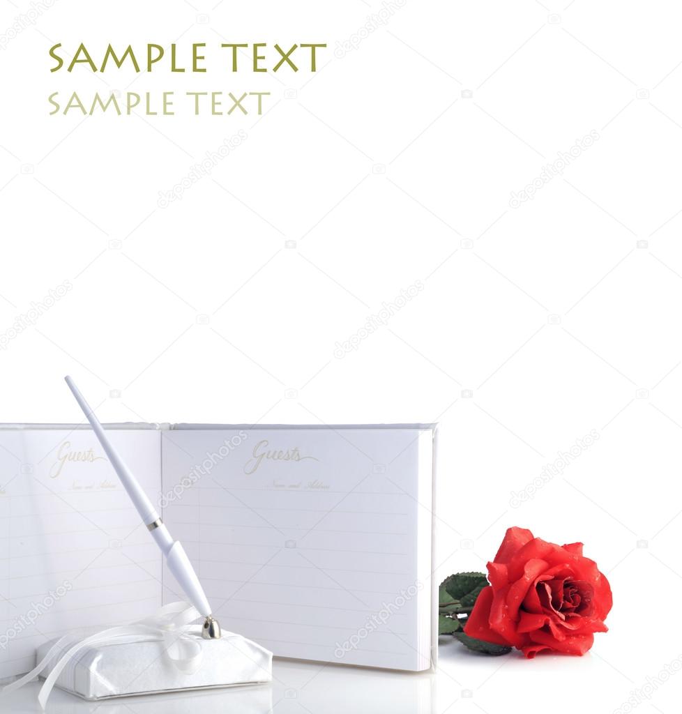 A beautiful red rose with water droplets and wedding guest book isolated on white - perfect for slides and presentations