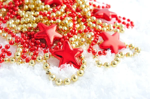 Christmas decorations of bauble are with stars on snow — Stock Photo, Image