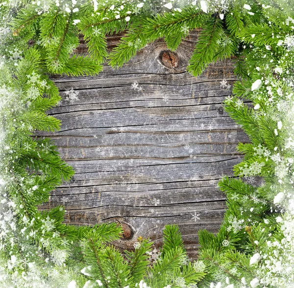 Insnöade grenar av Gran är på en gammal trä bakgrund — Stockfoto