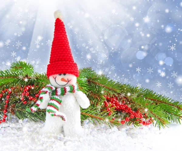 Snowman with the branches of fir and Christmas decorations on a festive background — Stock Photo, Image