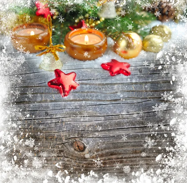 Christmas composition is with candles on a snowbound wooden background — Stock Photo, Image