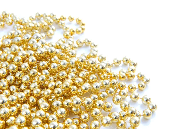Christmas gold beads are on a white background — Stock Photo, Image