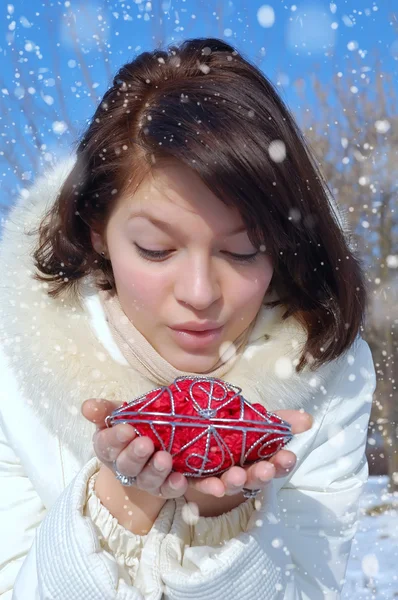 Menina de inverno com um coração decorativo — Fotografia de Stock