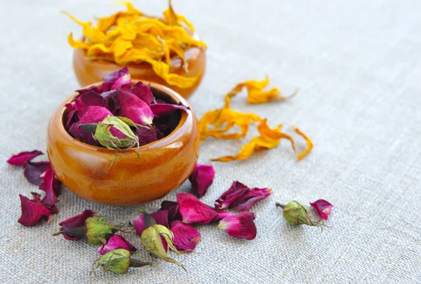 Dry healing flowers and petals in a cups on sackcloth, herbal medicine — Stock Photo, Image