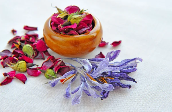Dry flowers of rose and saffron on sackcloth, herbal medicine — Stock Photo, Image