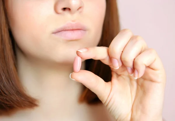 Young woman taking the pill. Focus is on a pill — Stock Photo, Image