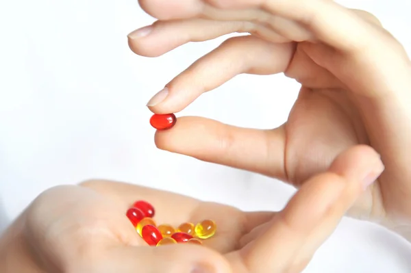 Hands holding capsules — Stock Photo, Image