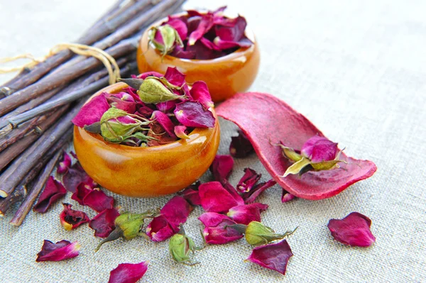 Dry healing flowers and petals in a cups on sackcloth — Stock Photo, Image