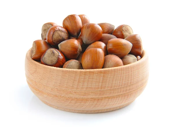 Hazelnuts in a wooden bowl on a white background — Stock Photo, Image