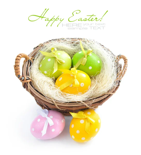 Easter eggs are in a basket on a white background — Stock Photo, Image