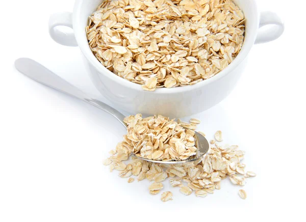 Oat flakes in bowl and spoon on on white background — Stok Foto