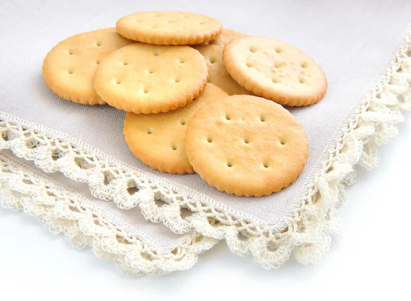 Crackers on beige linen napkin on a white background — Stock Photo, Image