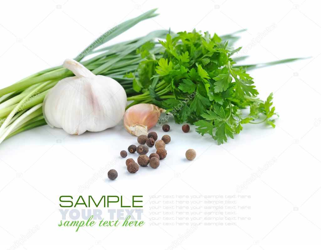 Grains of pepper are with a garlic and greenery of parsley on a white background