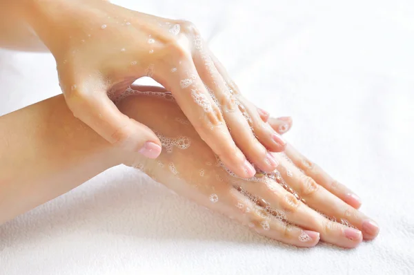 Washing woman hands on a background a white towel — Stock Photo, Image