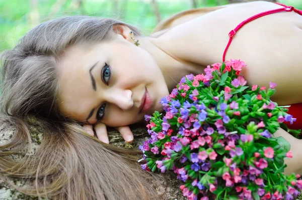 Krásná mladá žena s vůní jarních květin — Stock fotografie