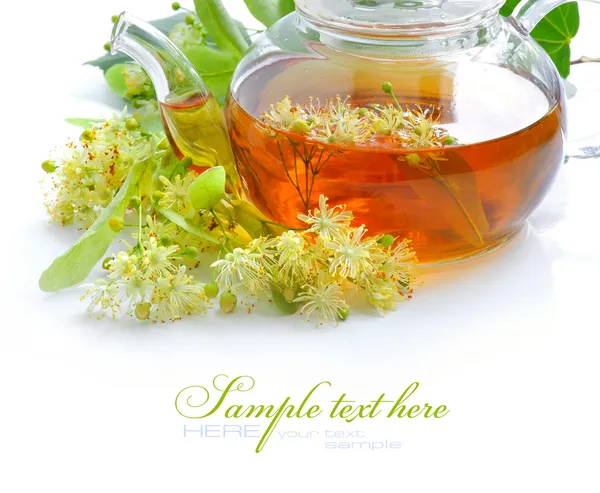 Teapot with linden tea and flowers — Stock Photo, Image