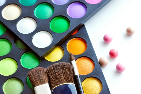 Paleta de sombras de ojos profesionales con pinceles de maquillaje sobre fondo blanco — Foto de Stock