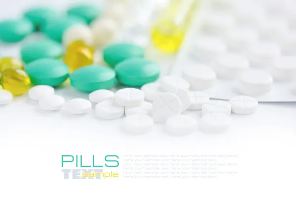 Color pills on white (with sample text) — Stock Photo, Image