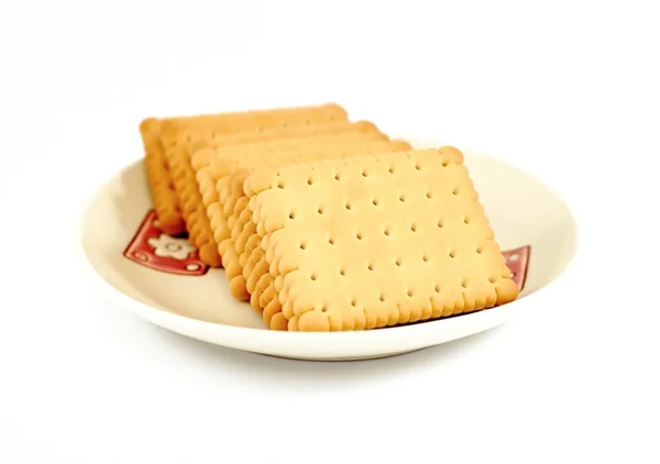 Heap of square crackers in plate on a white background — Stock Photo, Image